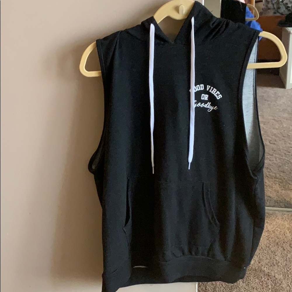 Sleeveless beach cover up with hood.